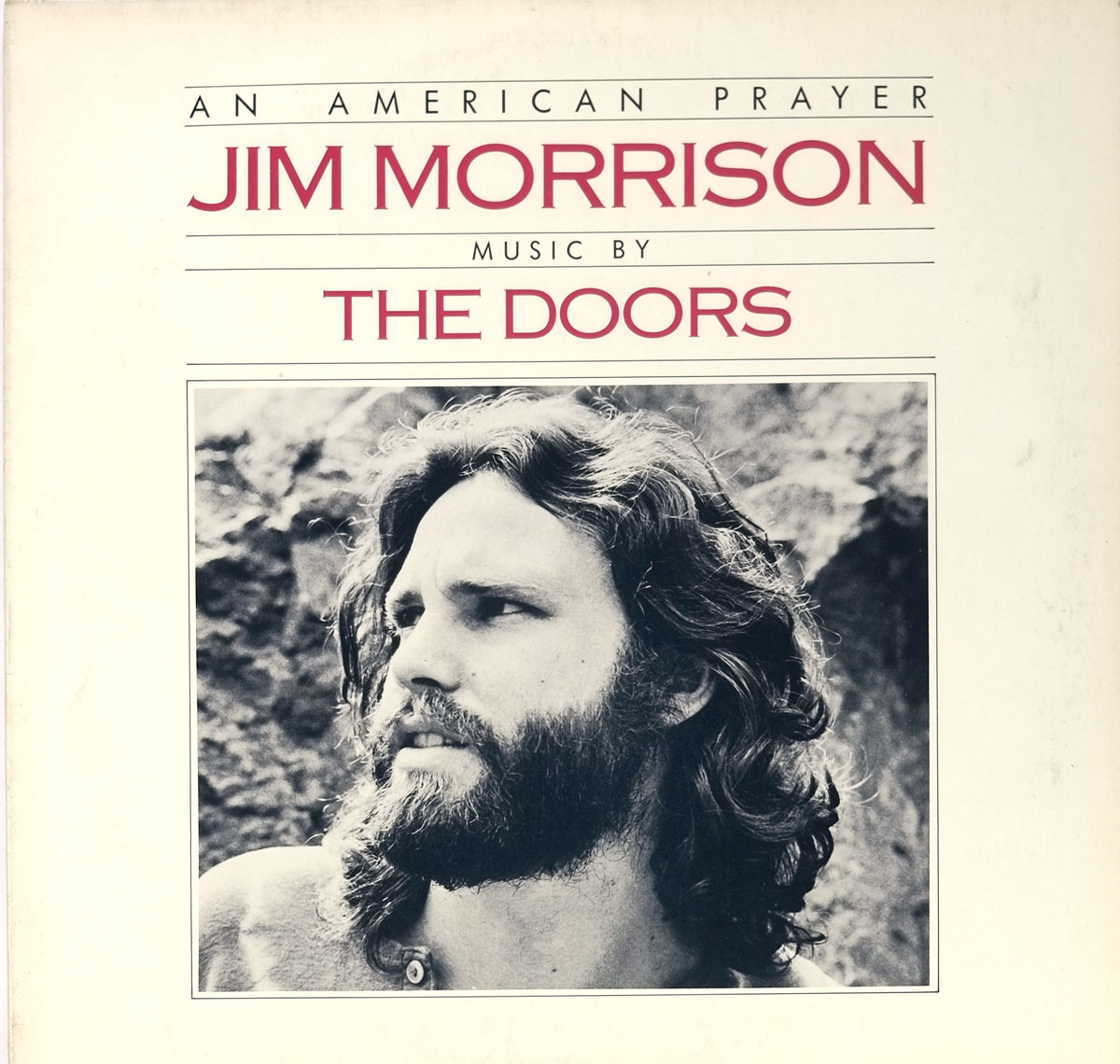 Album cover of An American Prayer by Jim Morrison and The Doors featuring a black-and-white portrait of Jim Morrison with long hair and a beard, set against a white background with red and black text displaying the album title and credits.